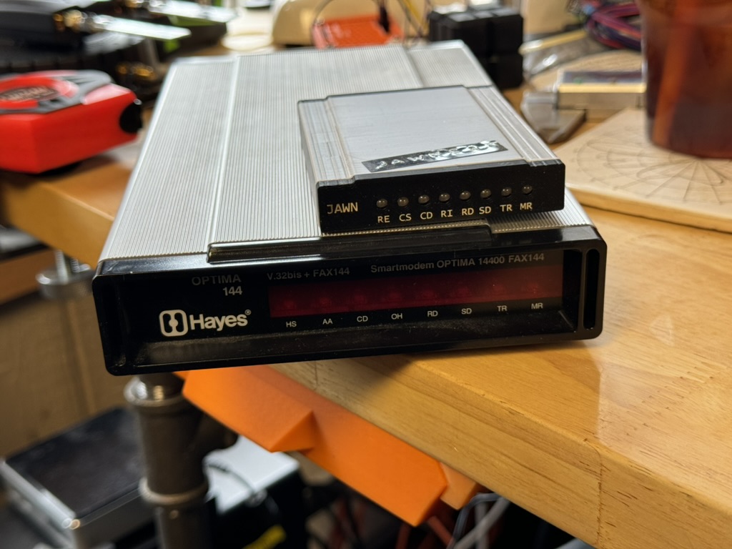 A Jawn badge on a Hayes modem